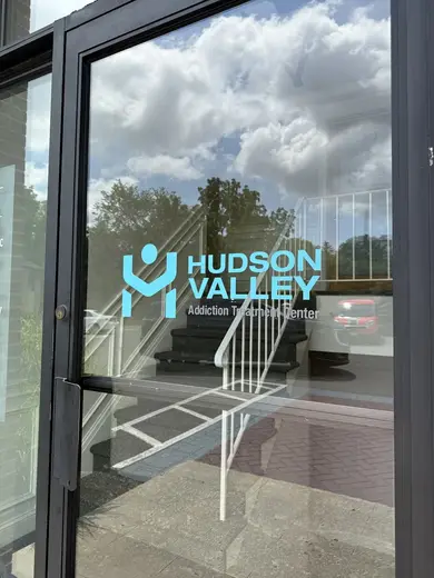 Glass entrance door with logo of Hudson Valley Addiction Treatment Center, a partial hospitalization program in Albany.